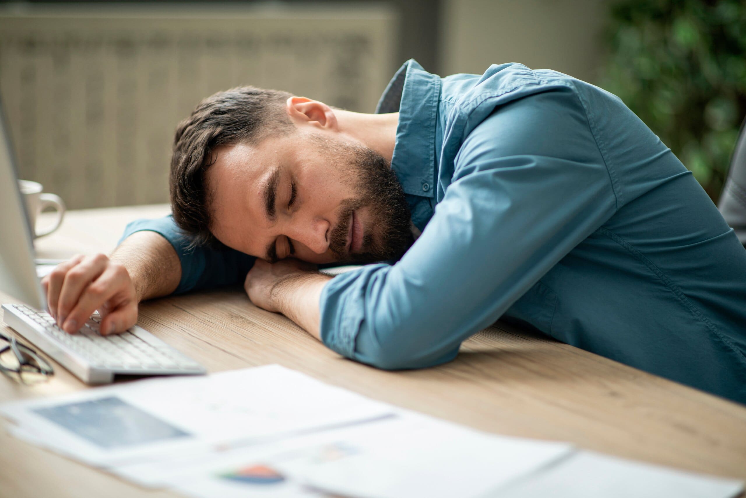 Man asleep at his desk.